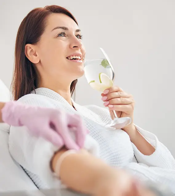drinking out of glass | IV Therapy | Aesthetica Med Spa In Austin, TX